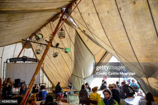 Festival goers enjoy food in a cafe at Wilderness Festival at Cornbury Park on August 10, 2014 in Oxford, United Kingdom.