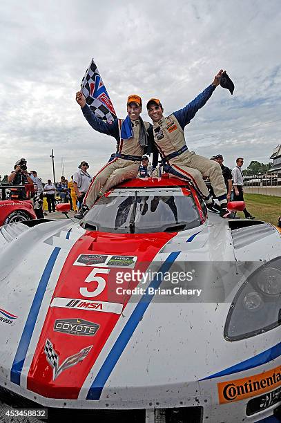 Joao Barbosa and Christian Fittipaldi celebrate after winning the IMSA Tudor Series race at Road America on August 10, 2014 in Elkhart Lake,...