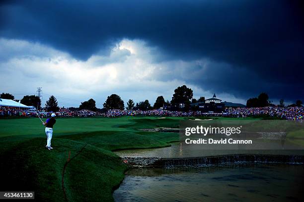 Rory McIlroy of Northern Ireland hits his second shot on the 18th hole during the final round of the 96th PGA Championship at Valhalla Golf Club on...