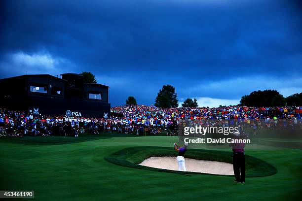 Rory McIlroy of Northern Ireland hits a shot from a greenside bunker on the 18th hole during the final round of the 96th PGA Championship at Valhalla...