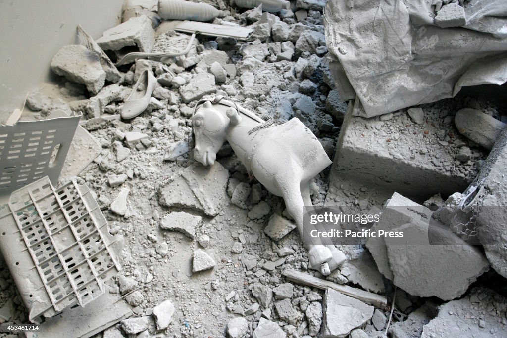 A toy lying on the wreckage of the house was hit by an...