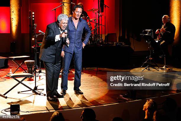 Singer Enrico Macias singing with Dani Brillant front of dani's wife Nathalie Moury as he gives a concert at the 30th Ramatuelle Festival : Day 10 on...