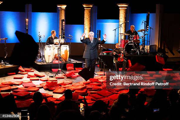 Singer Enrico Macias during the traditional throw of cushions at the final of his concert at the 30th Ramatuelle Festival : Day 10 on August 10, 2014...