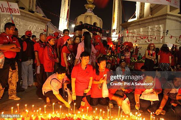 Anti-government protesters pray infront of a spot where candles are laid in memory of the protesters who lost their lives during a demonstration at...