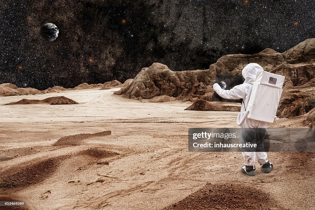Astronaut Studying Map On Mars or the Moon