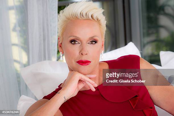 Brigitte Nielsen poses in a dress of Basler during a Portrait Session on July 6, 2014 in Milano,Italy.