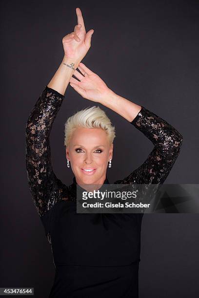 Brigitte Nielsen, wearing a dress of Basler, poses during a portrait session on July 6, 2014 in Milan, Italy.