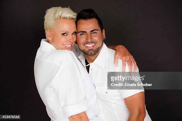 Brigitte Nielsen and husband Mattia Dessi pose during a Portrait Session on July 6, 2014 in Milano,Italy.