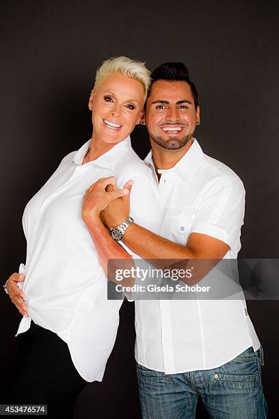 Brigitte Nielsen and husband Mattia Dessi pose during a Portrait Session on July 6, 2014 in Milano,Italy.