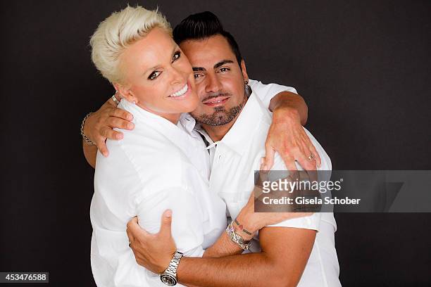 Brigitte Nielsen and husband Mattia Dessi pose during a Portrait Session on July 6, 2014 in Milano,Italy.