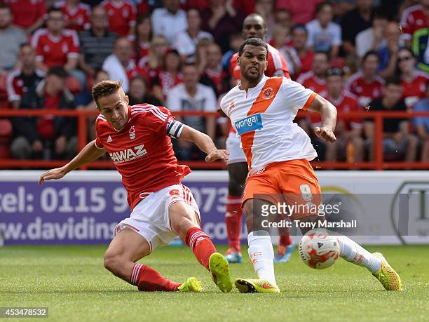 Chris Cohen of Nottingham Forest tackles Jacob Mellis of Blackpool during the Sky Bet Championship match between Nottingham Forest and Blackpool at...