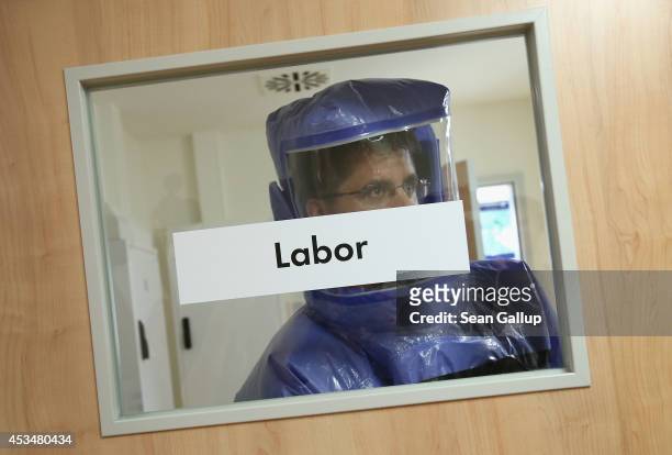 Doctor for tropical medicine leaves a laboratory during a demonstration for the media of ebola treatment capabilities at Station 59 at Charite...