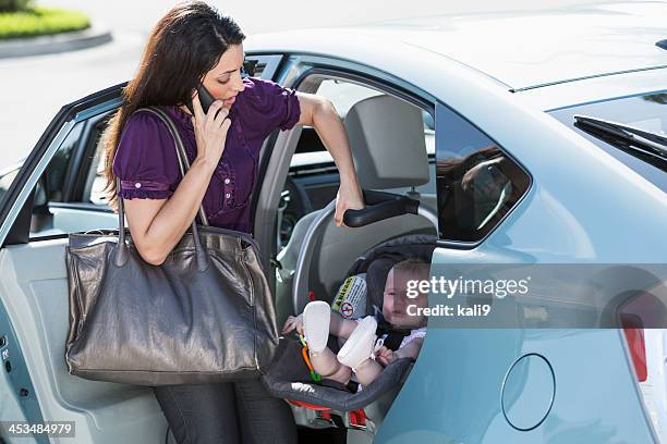 woman traveling with baby on phone - car arrival stock pictures, royalty-free photos & images