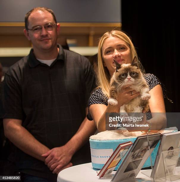 Bryan Bundesen and Tabby Bundesen arrive with Grumpy Cat at Indigo in the Eaton Centre in Toronto, August 9, 2014.