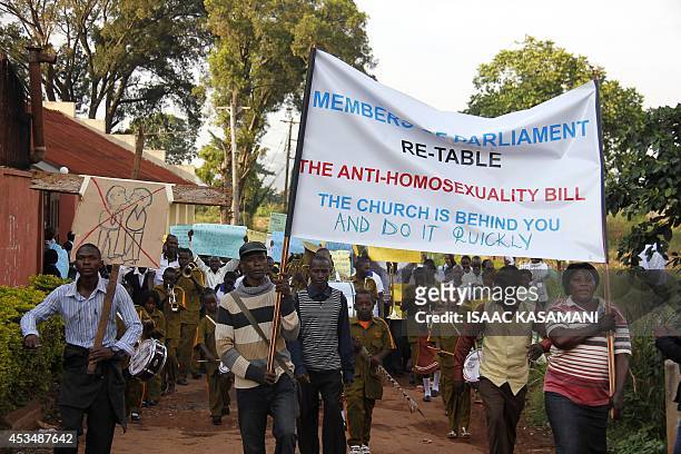 Anti-Homosexual activists march on the streets of Kampala carrying placards on August 11, 2014 to demonstrate against the recently annulled Anti-Gay...