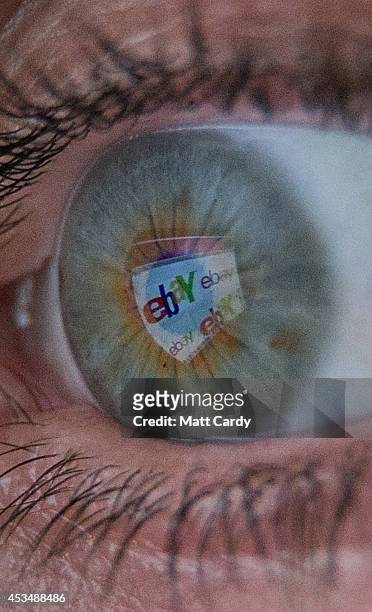 In this photo illustration a woman has the online retailer eBay logo reflected in her eye as she shops online on August 11, 2014 in Bristol, United...