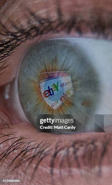 In this photo illustration a woman has the online retailer eBay logo reflected in her eye as she shops online on August 11, 2014 in Bristol, United...