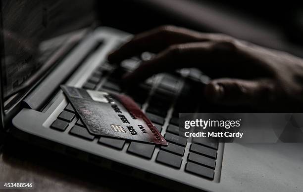 In this photo illustration a woman uses a credit card to buy something online on August 11, 2014 in Bristol, United Kingdom. This week marks the 20th...