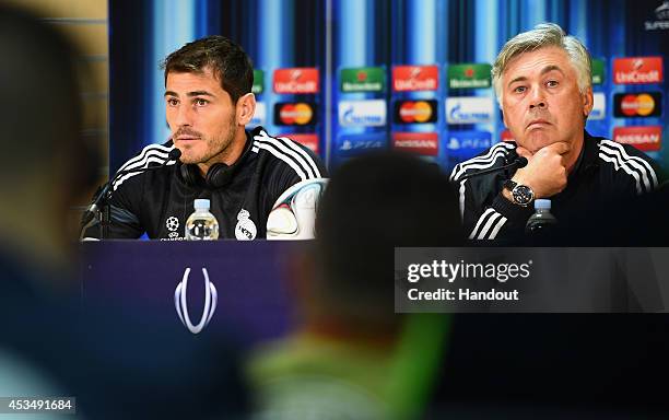 In this handout image provided by UEFA, Iker Casillas of Real Madrid and Real Manager Carlo Ancelotti during the Real Madrid press conference at...