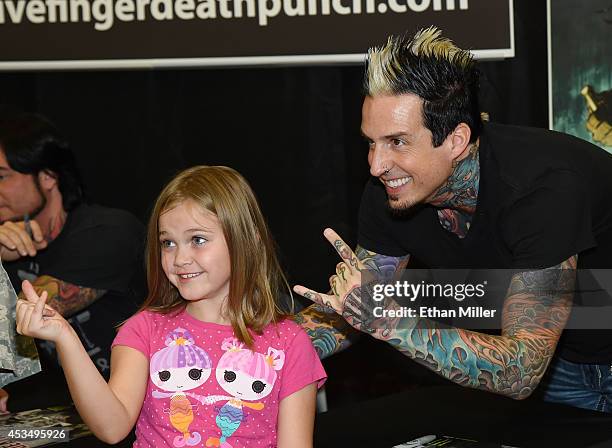 Rachel Allen poses for a photo with drummer Jeremy Spencer of Five Finger Death Punch at Nellis Air Force Base as the band highlights its campaign to...