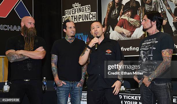 Bassist Chris Kael, drummer Jeremy Spencer, and guitarists Zoltan Bathory and Jason Hook of Five Finger Death Punch speak at Nellis Air Force Base as...