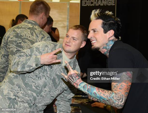 Staff Sgt. Michael Gigliotti poses for a photo with drummer Jeremy Spencer of Five Finger Death Punch at Nellis Air Force Base as the band highlights...
