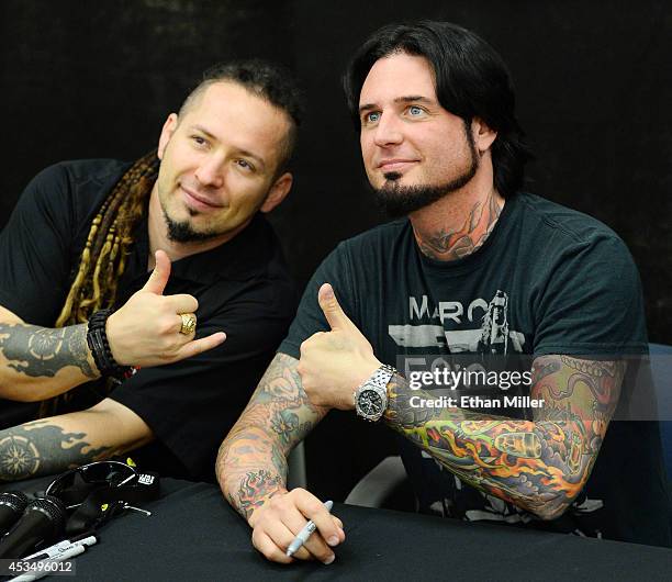 Guitarists Zoltan Bathory and Jason Hook of Five Finger Death Punch pose for photos at Nellis Air Force Base as the band highlights its campaign to...
