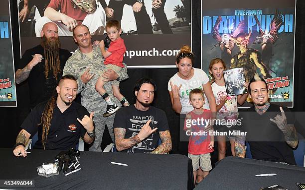 Master Sgt. Todd Badger and members of his family pose with bassist Chris Kael , guitarist Zoltan Bathory , guitarist Jason Hook and drummer Jeremy...