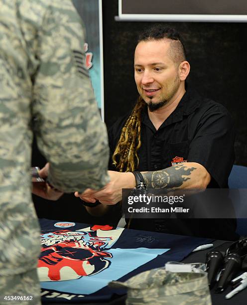 Guitarist Zoltan Bathory of Five Finger Death Punch signs autographs at Nellis Air Force Base as the band highlights its campaign to raise awareness...