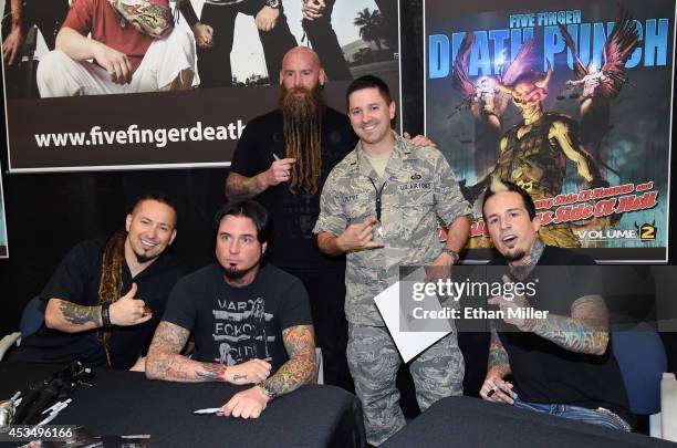 Lt. Brian Pettit poses for a photo with guitarists Zoltan Bathory and Jason Hook, bassist Chris Kael and drummer Jeremy Spencer of Five Finger Death...
