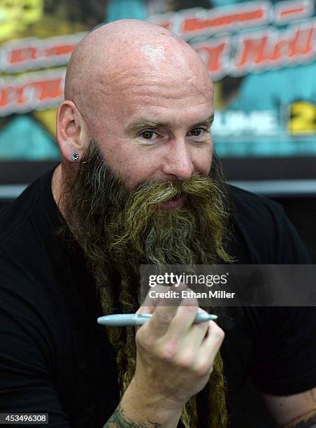 Bassist Chris Kael of Five Finger Death Punch poses for a photo at Nellis Air Force Base as the band highlights its campaign to raise awareness about...