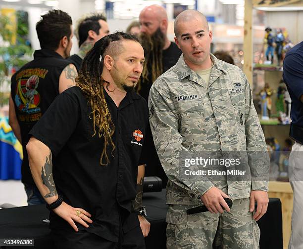 Guitarist Zoltan Bathory of Five Finger Death Punch talks with Senior Airman Zachary Barkhymer at Nellis Air Force Base as the band highlights its...