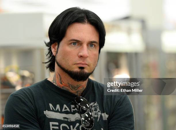 Guitarist Jason Hook of Five Finger Death Punch watches the group's new video being shown at Nellis Air Force Base as the band highlights its...