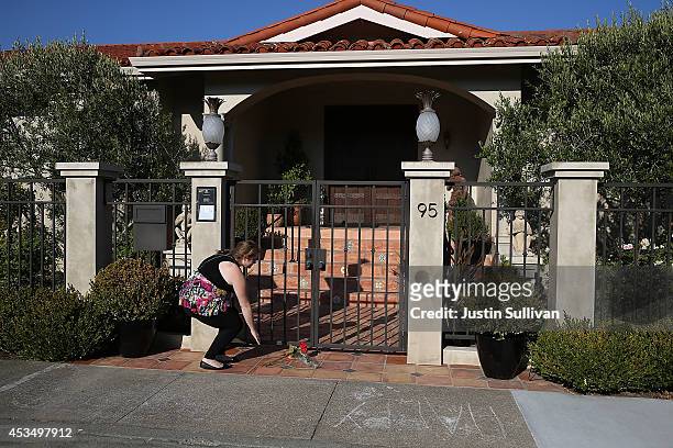 Well wisher leaves flowers in front of the home of actor and comedian Robin Williams on August 11, 2014 in Tiburon, California. Academy Award-winning...