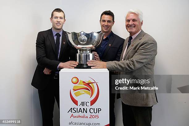 Brett Emerton, Paul Okon and Rale Rasic pose with the Asian Cup Trophy during the AFC Asian Cup Ambassador Announcement at the LOC Offices on August...