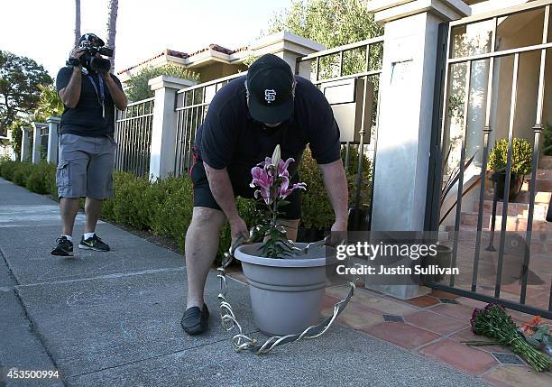 Well wisher leaves flowers in front of the home of actor and comedian Robin Williams on August 11, 2014 in Tiburon, California. Academy Award-winning...