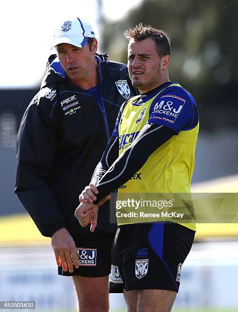 Josh Reynolds talks with assistant Kelly Egan during a Canterbury Bulldogs NRL training session at Belmore Sports Ground on August 12, 2014 in...