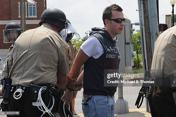 Man is arrested during a protest of the shooting death of 18-year-old Michael Brown outside Ferguson Police Department Headquarters August 11, 2014...