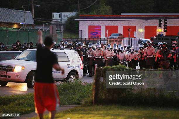 Police force protestors from the business district into nearby neighborhoods on August 11, 2014 in Ferguson, Missouri. Police responded with tear gas...