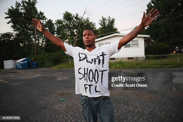 Protesters are forced by police from the business district into nearby neighborhoods on August 11, 2014 in Ferguson, Missouri. Police responded with...