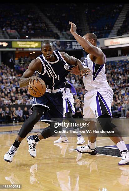 Serge Ibaka of the Oklahoma City Thunder drives on Chuck Hayes of the Sacramento Kings at Sleep Train Arena on December 3, 2013 in Sacramento,...