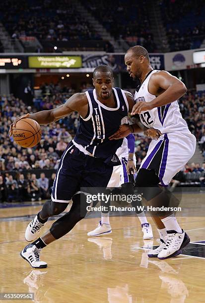 Serge Ibaka of the Oklahoma City Thunder drives on Chuck Hayes of the Sacramento Kings at Sleep Train Arena on December 3, 2013 in Sacramento,...