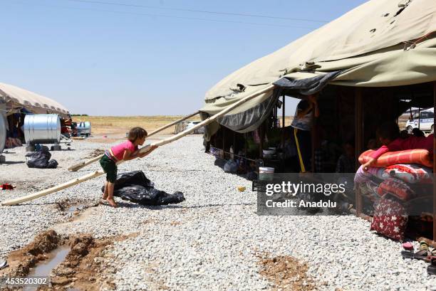 Iraqi Yezidi refugees escaping from attacks of Islamic State, try to hold on life in Sirnak city of Turkey on August 12, 2014. Iraqi Yezidi people...