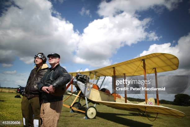 Navigator Stephen Slater and pilot Matthew Boddington stand with a replica BE-2 biplane of the Royal Flying Corp comes into land on August 12, 2014...