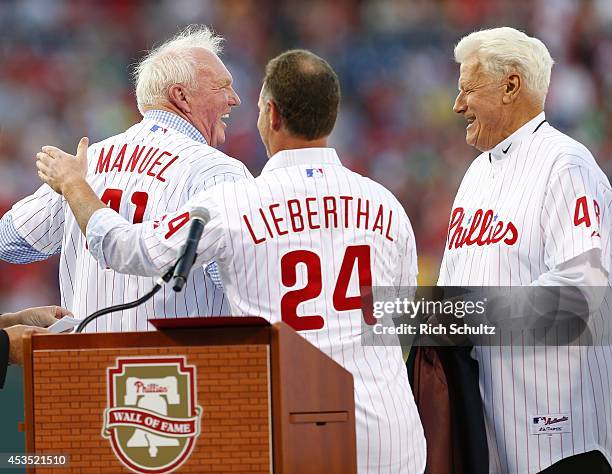 Former manager Charlie Manuel of the Philadelphia Phillies is presented with his Wall of Fame jersey by Mike Lieberthal as Dallas Green looks on,...