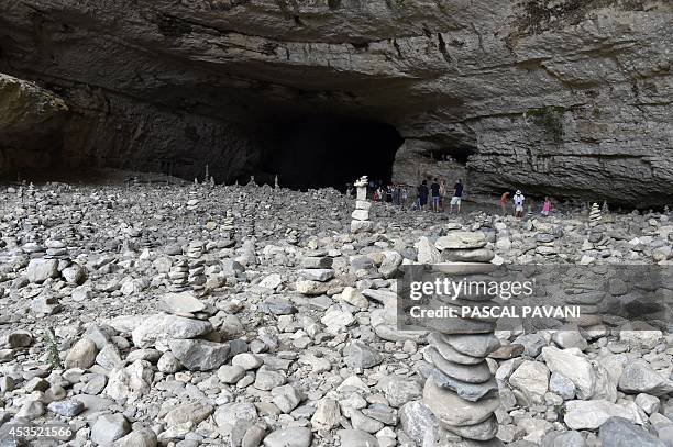 Photo of cairns at the exit of the 228m long natural tunnel "Pont Grand" near Minerve's Cathar village, in the Herault department, southern France on...