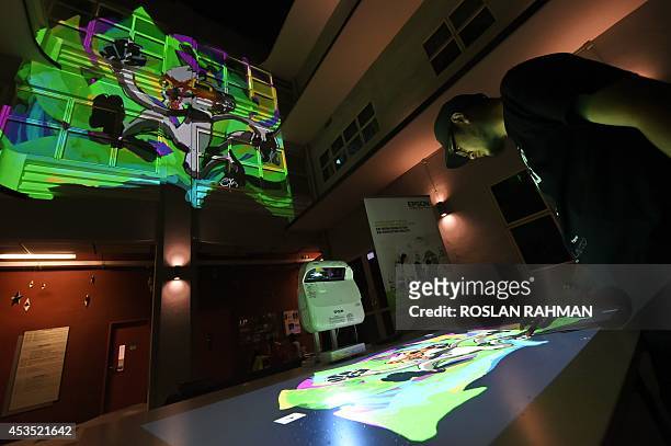 Local Singaporean artist vitually paints graffiti which projected from Epsons revolutionary 3LCD projection technology to a building facade during a...