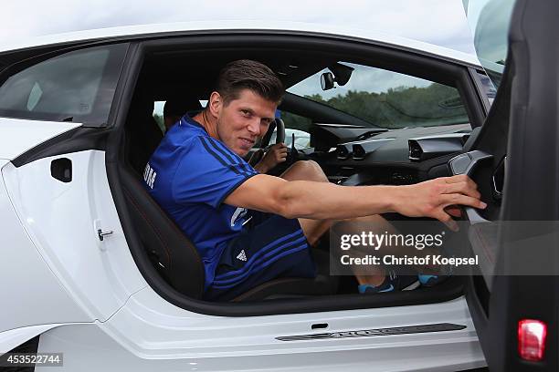 Klaas-Jan Huntelaar of Schalke closes the door of a Lamborghini during a test drive at driving safety centre Rheinberg on August 12, 2014 in...