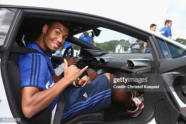 Eric Choupo-Moting of Schalke sits in a car during a test drive at driving safety centre Rheinberg on August 12, 2014 in Rheinberg, Germany.