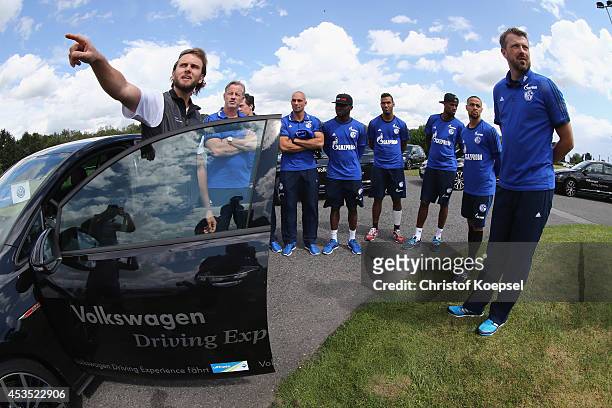 The team of Schalke get instructions by a test driver during a test drive at driving safety centre Rheinberg on August 12, 2014 in Rheinberg, Germany.